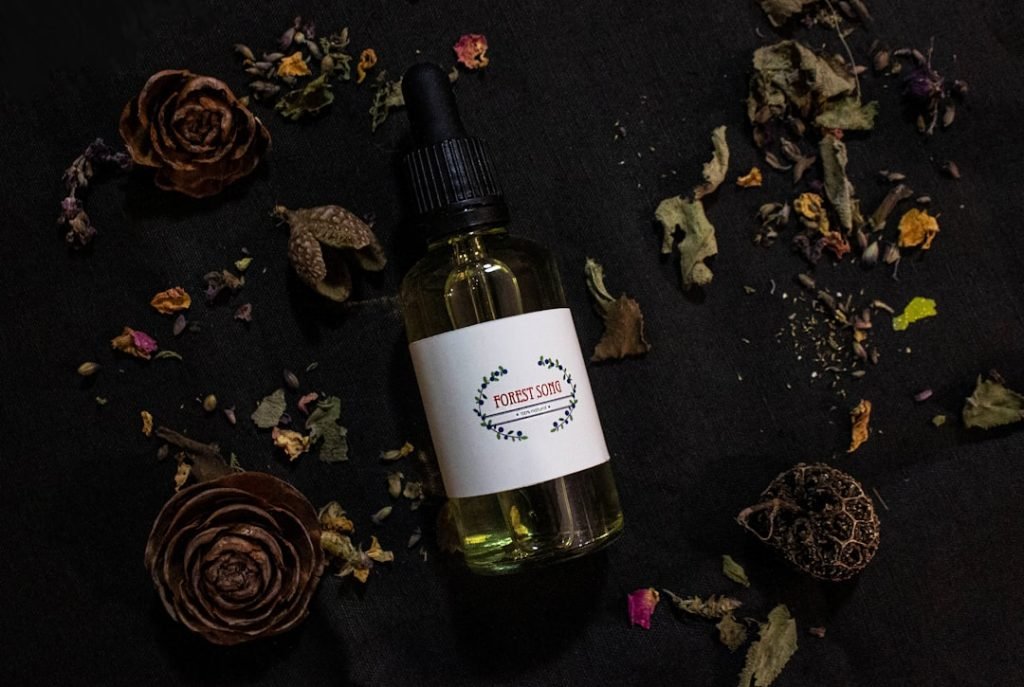a-bottle-of-essential-oil-surrounded-by-dried-flowers-aqoqgig3qga