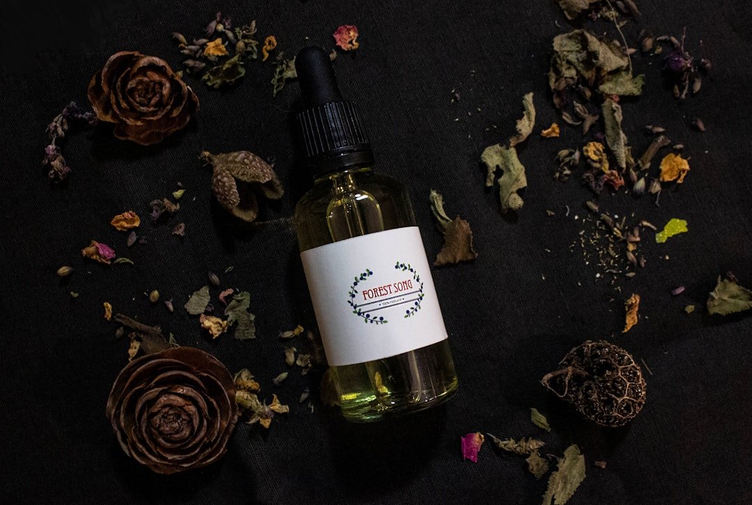 a-bottle-of-essential-oil-surrounded-by-dried-flowers-aqoqgig3qga